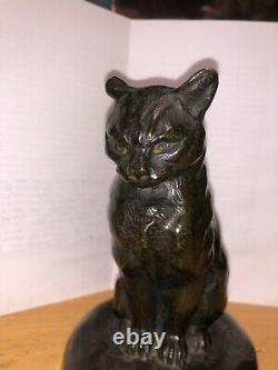 Cat Sitting In Front Of A Bronze Snail Sign Mohler, Cast Old Belle Qualite