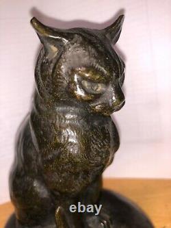 Cat Sitting In Front Of A Bronze Snail Sign Mohler, Cast Old Belle Qualite