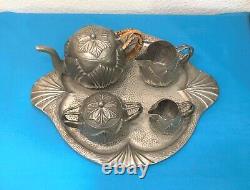 Translation: Old ART DECO tea and coffee service in pewter, signed Alice and Eugène CHANAL, with tray.